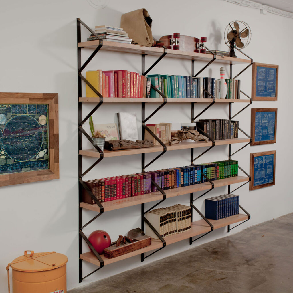 Half Rhombus Shelf installed on wall, shelf filled with books