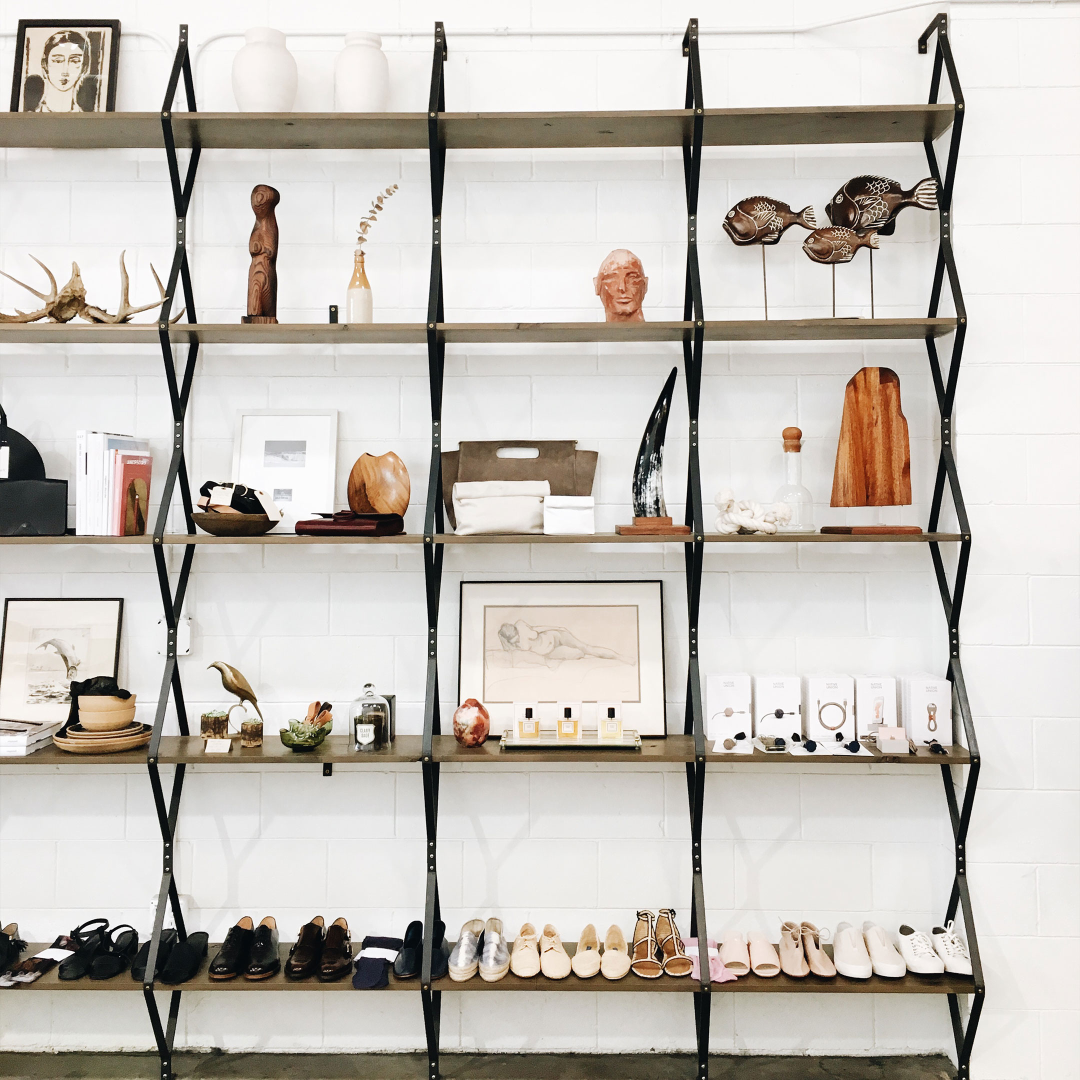 Rhombus Shelf installed in store with shoes and trinkets on it. Photo from Alchemy Works in the Arts District of DTLA