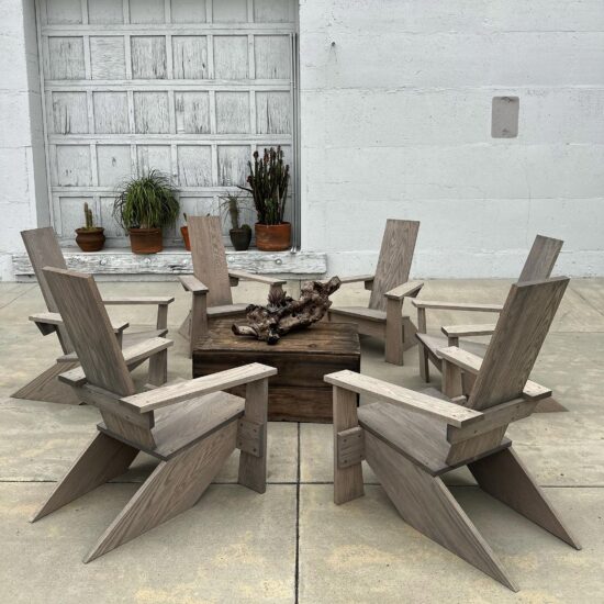 Westport Adirondack Chairs in a circle, 6 chairs around a table with a sculptural piece of wood