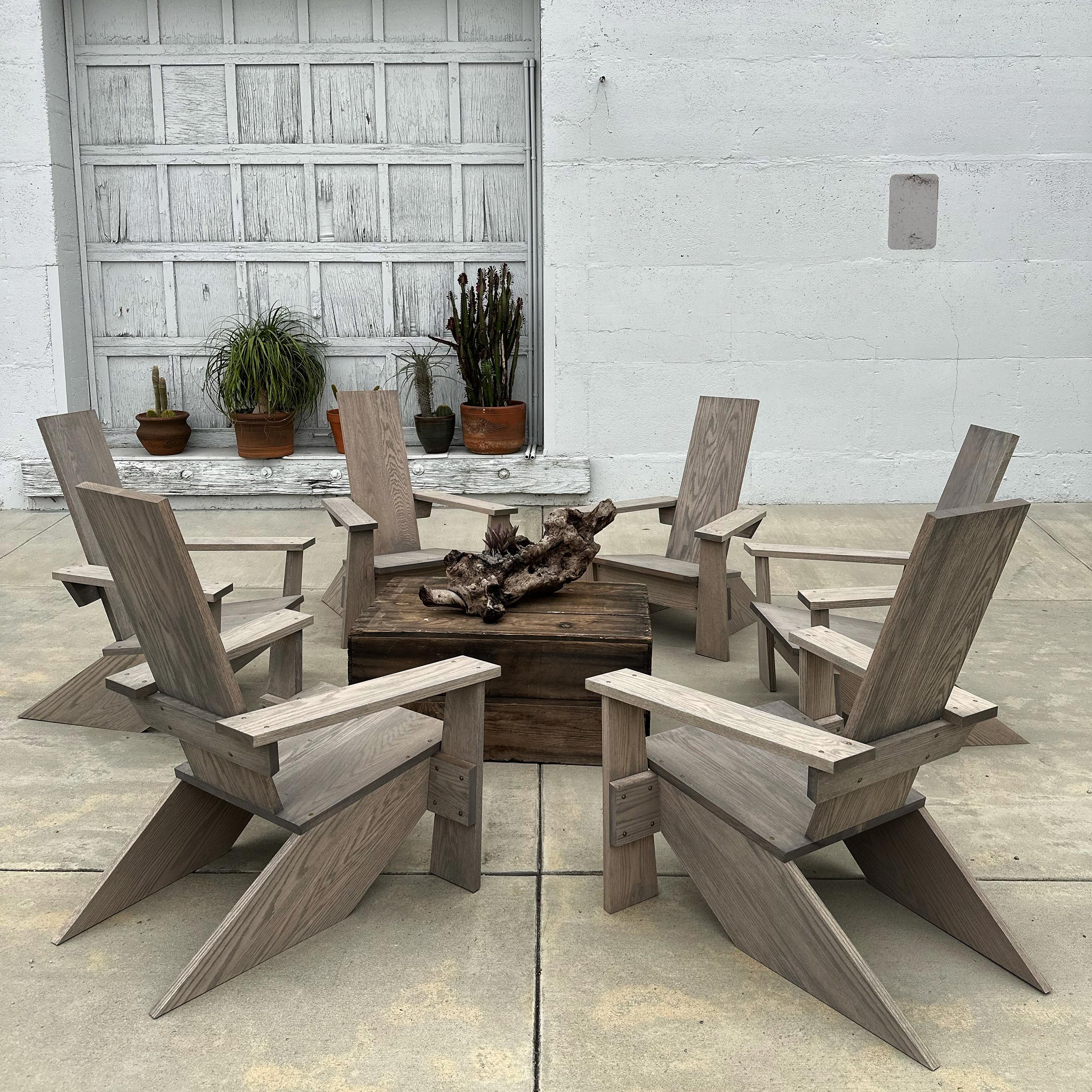 Westport Adirondack Chairs in a circle, 6 chairs around a table with a sculptural piece of wood